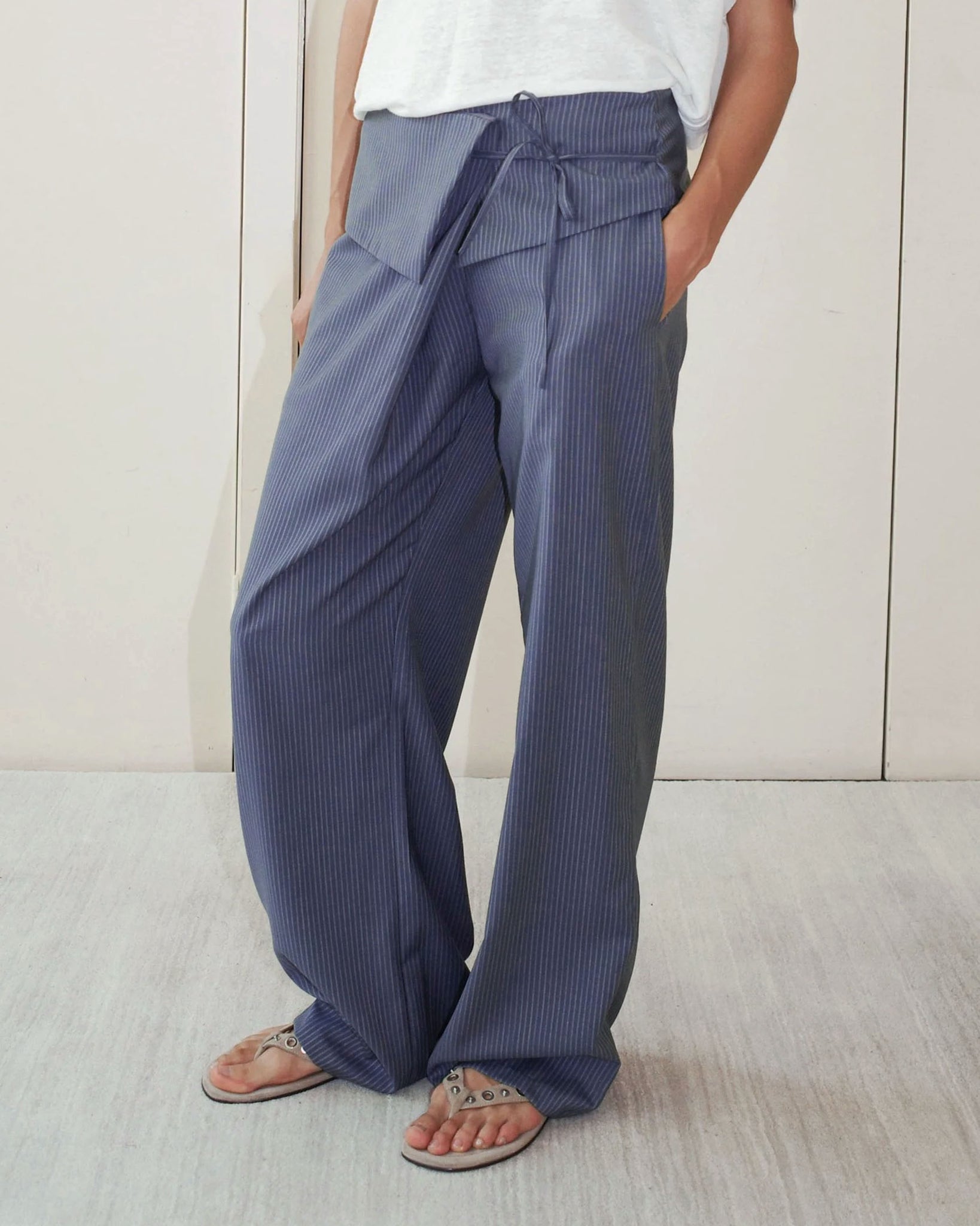 Model wearing the Deiji Studios Folded Wool Pant in Navy Stripe 