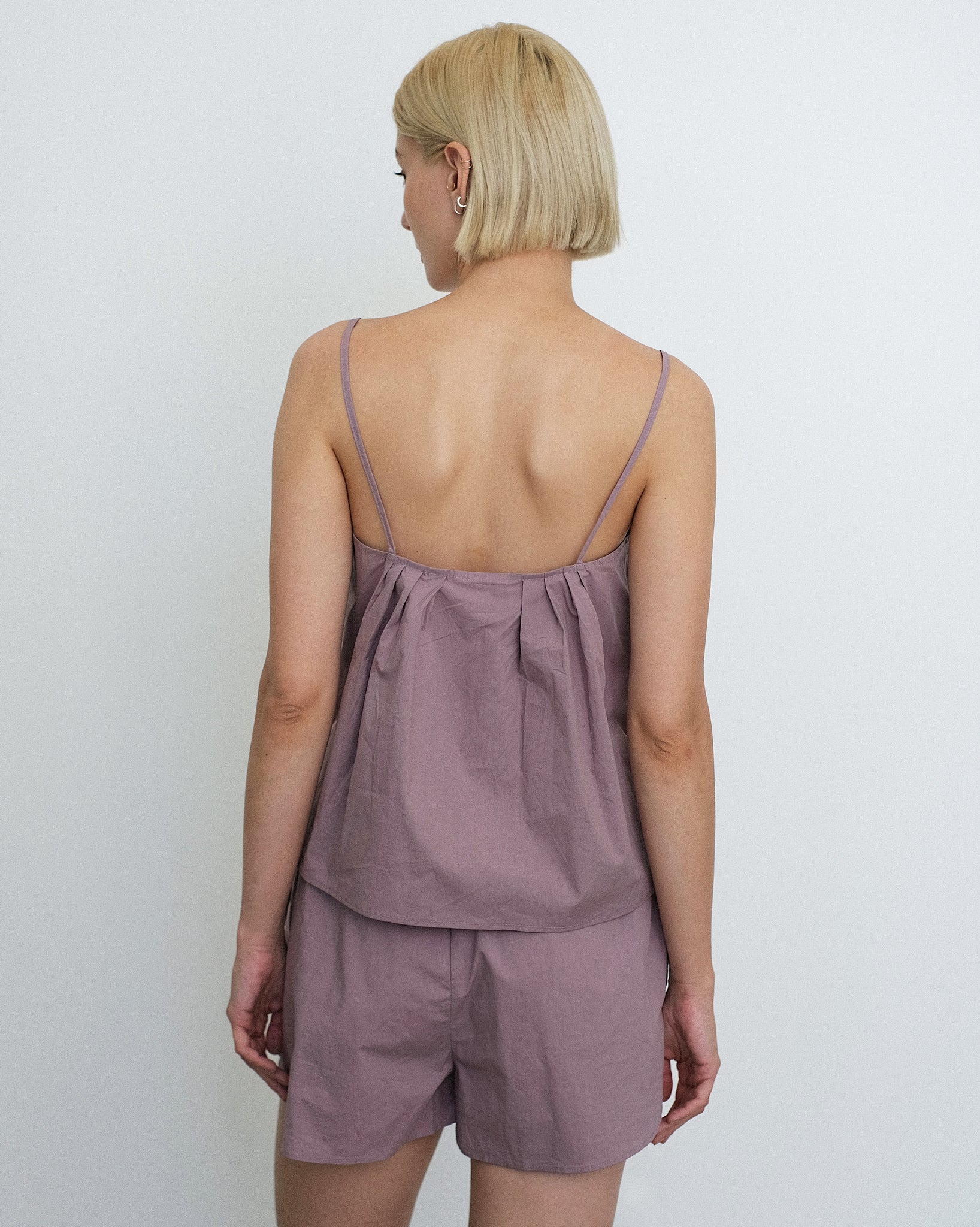 Rear View of Model wearing the Deiji Studios Pleat Set in Organic, Mauve Cotton Poplin 