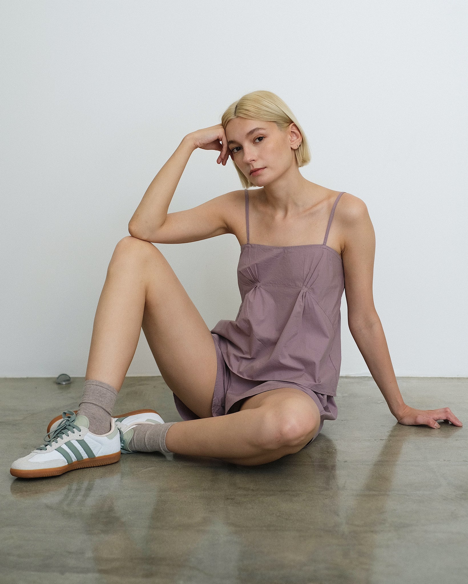 Model sitting in the Deiji Studios Pleat Set in Organic, Mauve Cotton Poplin 