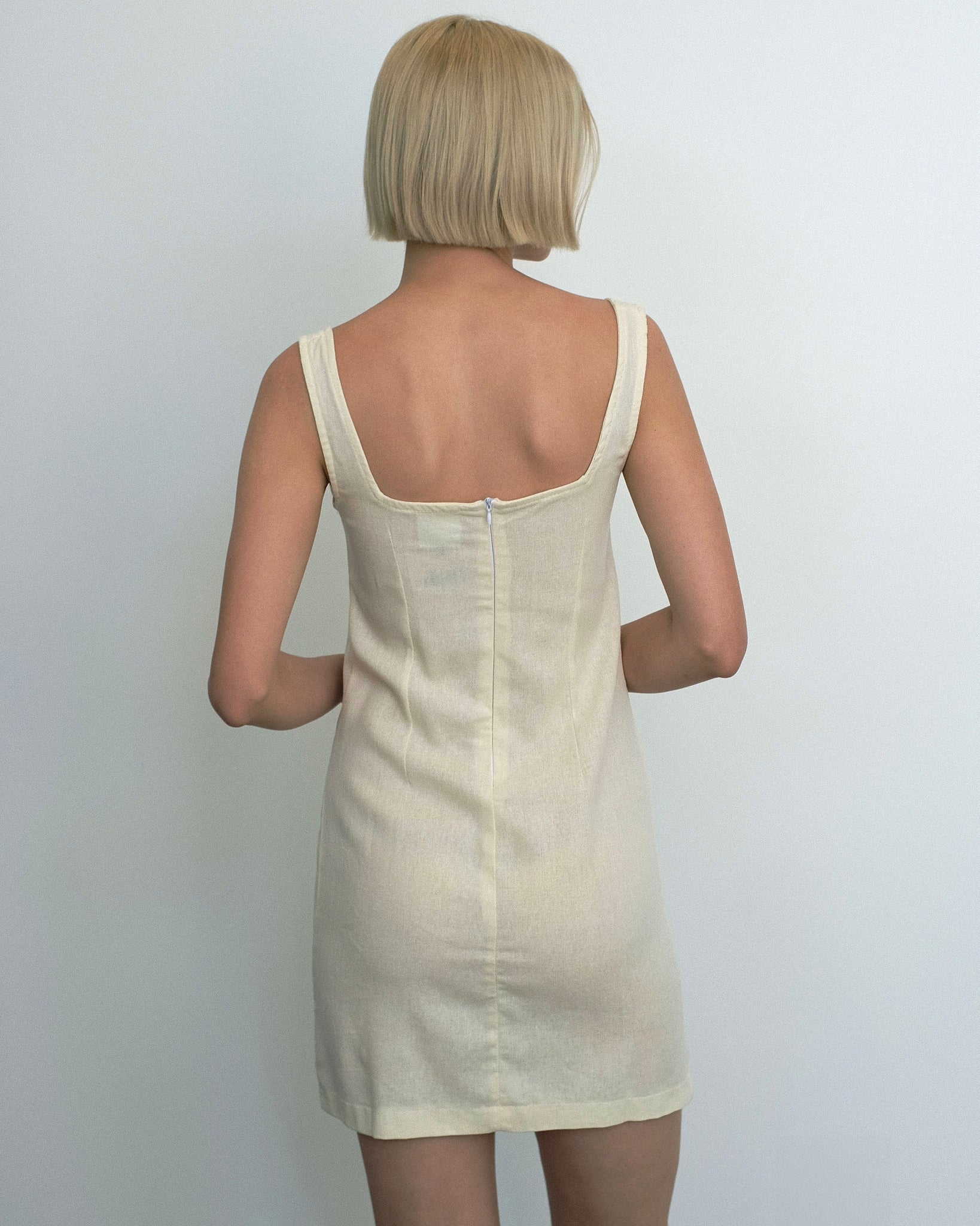 Model wearing the Marina Dress in ivory linen from Tach